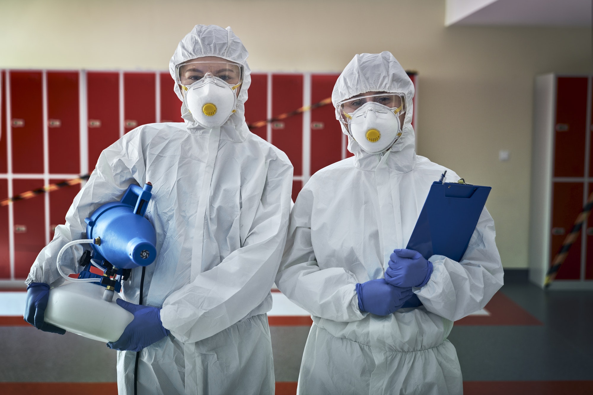 portrait-of-two-woman-in-disinfection-suits-ready-for-disinfection.jpg